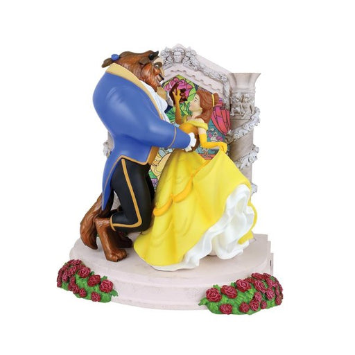 Belle is presented in her iconic yellow ball gown. With the beast in his blue long tailed suit jacket, whilst the duo stand in front of the stained glass window dancing. They are surrounded by red roses.