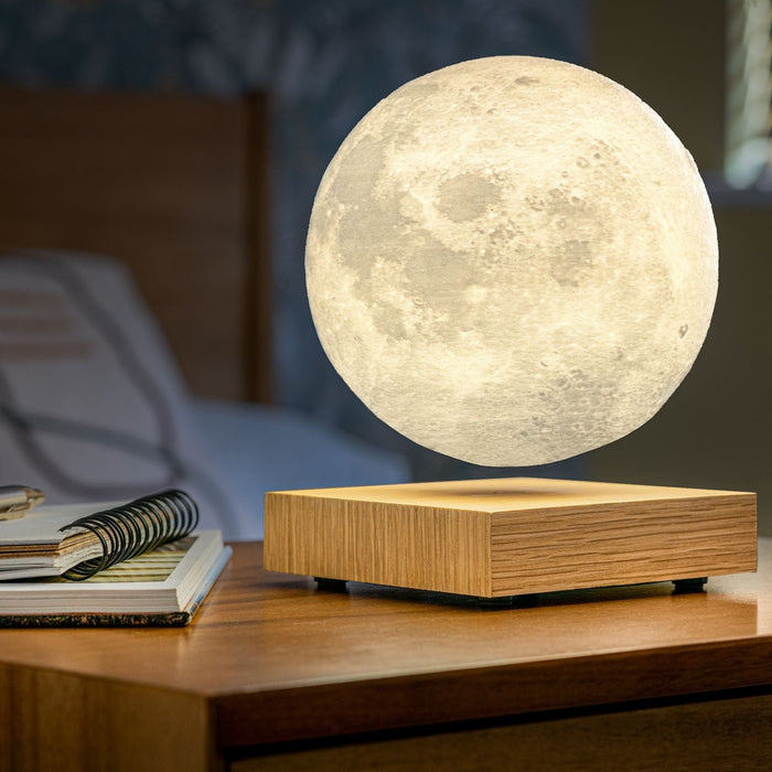 gingko smart 3d printed floating LED moon lamp on a white ash base