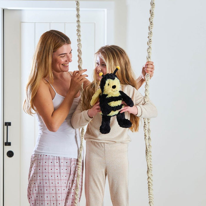 Mother and Daughter Holding the Warmies bumblebee whilst on a swing.