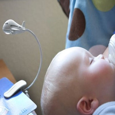 Airplane night light being used whilst feeding a sleeping baby. 