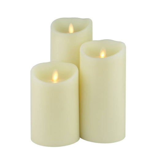 a bundle of cream candles of different sizes illuminated