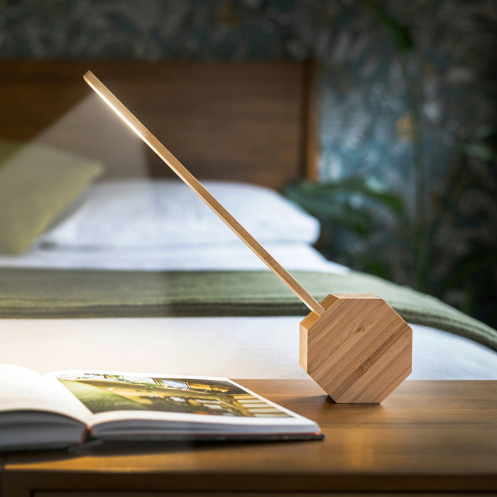 Bamboo Gingko Octagon LED Light On A Bedroom Table At Night Shining Light Over A Book