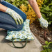 A lady using the lemon patterned kneeler and matching gardening gloves whilst gardening.