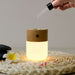 gingko white ash effect smart diffuser being filled with essential oils using a pippette