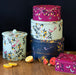Sara Miller Orchard Storage Tin Collection Set Against  A Wooden Surface