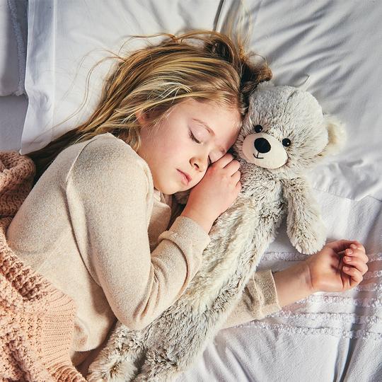 young girl sleeping with marshmllow grey teddy bear