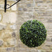 Artificial Topiary Hanging Ball In Garden/Outdoor Space attached to wall.