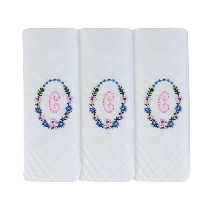 Three pack of white handkerchiefs displaying an embroidered letter C in pink with a floral boarder around the letter.