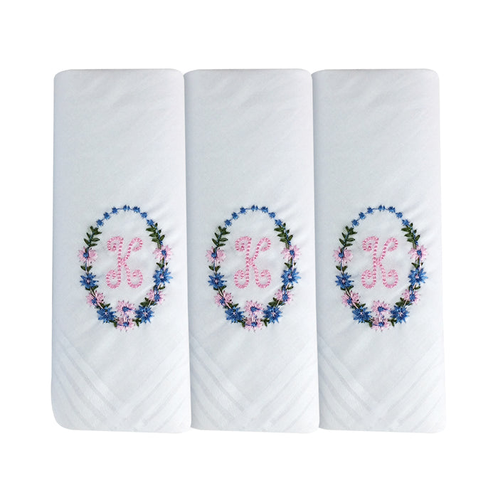 Three pack of white handkerchiefs displaying an embroidered letter K in pink with a floral boarder around the letter.