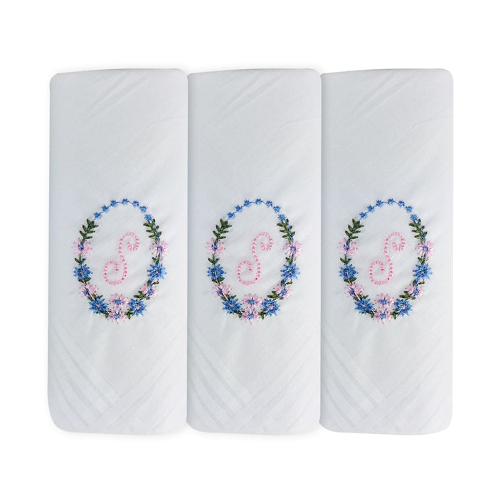 Three pack of white handkerchiefs displaying an embroidered letter S in pink with a floral boarder around the letter.