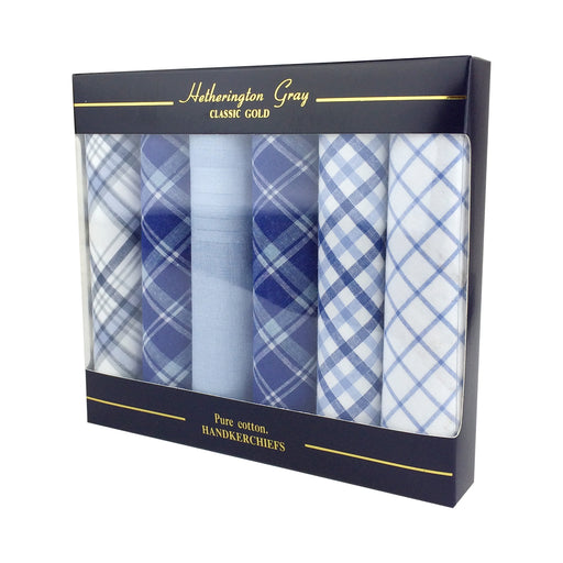 Set of 6 rolled handkerchiefs is a gift box. The handkerchiefs are all a different shade of blue check 