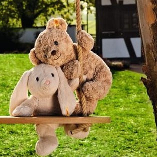 Plush Bears On An Outdoor Wooden Swing