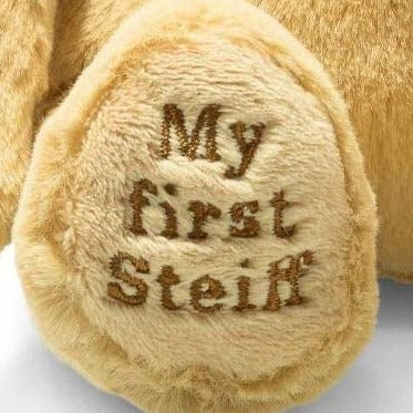A image of the foot with 'my first steiff' embroidered in a golden brown thread.