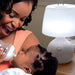 baby bright led sensor light lamp in white next to baby being fed