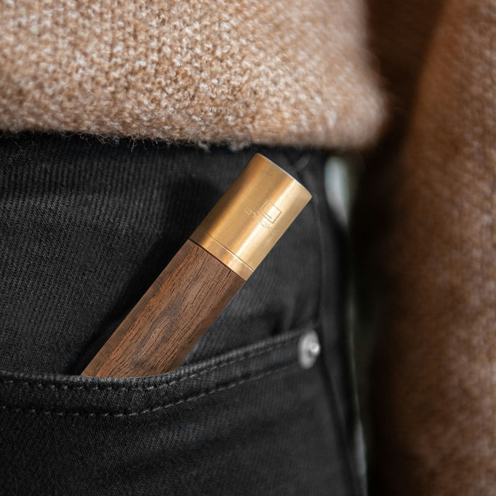gingko natural wood flameless lighter in american walnut placed in the pocket of a pair of black jeans