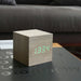 Gingko Cube LED click clock in an ash coloured wooden effect displaying the time in green