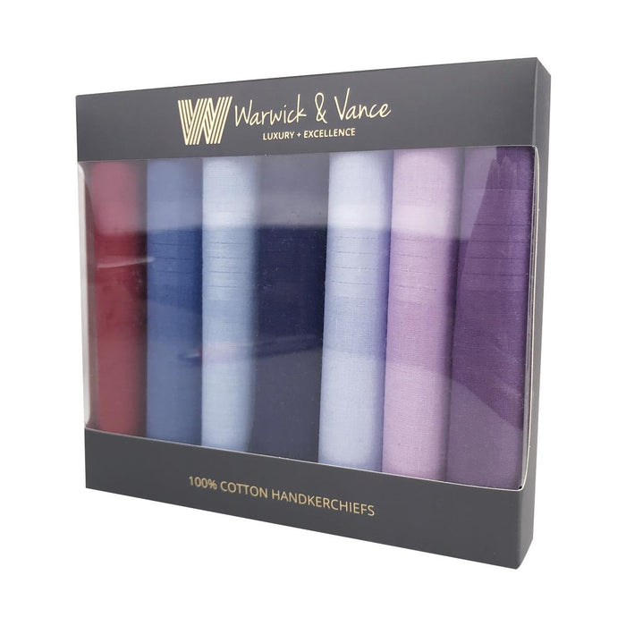 A set of 7 rolled up handkerchiefs presented in a gift box. The handkerchiefs are each a different colour and vary from purple, pink, navy, blue and red.