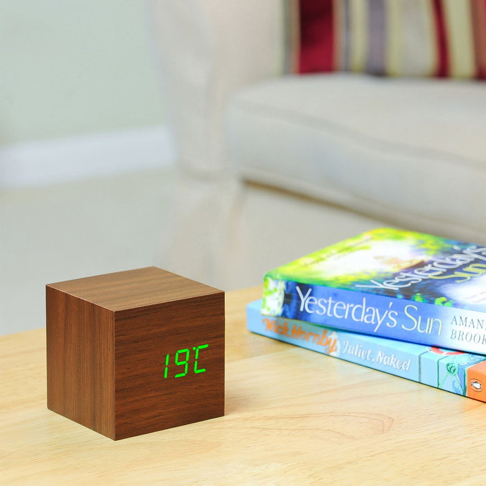 Gingko Cube LED click clock in a walnut coloured wooden effect displaying the temperature in green