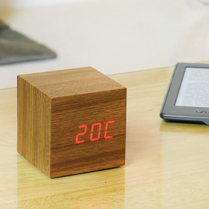 Gingko Cube LED click clock in a teak effect displaying the temperature in red