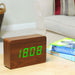 Gingko brick LED click clock in a walnut coloured wooden effect displaying the time in light green