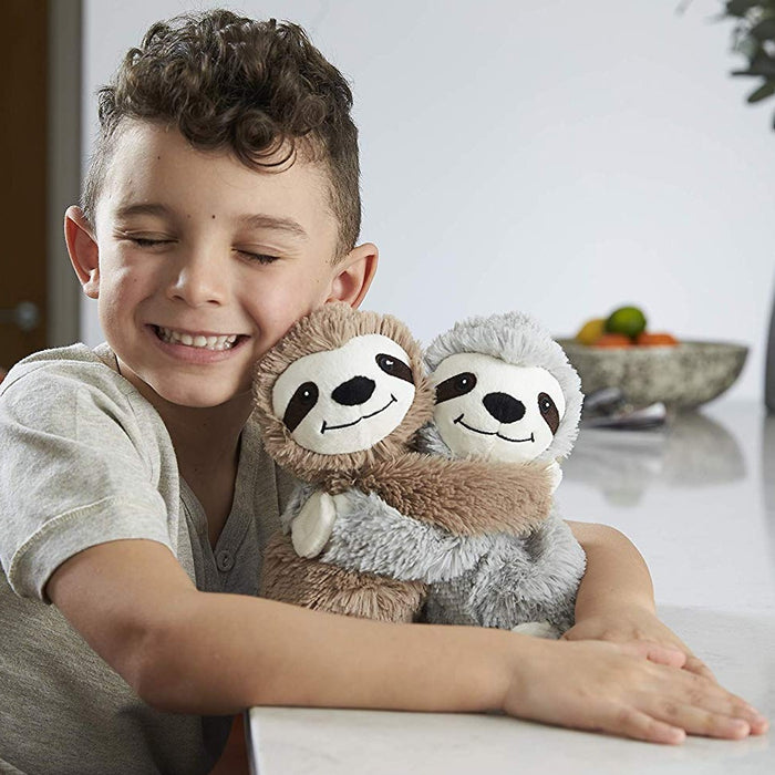 young boy holding warmies warm hugs sloths